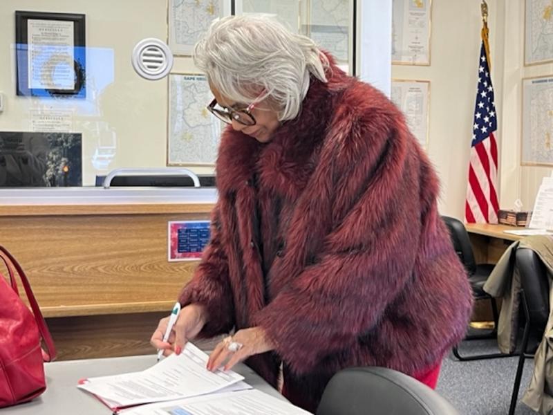 Rep. Stell Parker Selby, D-Milton, signs the official paperwork at the Department of Elections in Georgetown to run for her second term. SUBMITTED PHOTOS